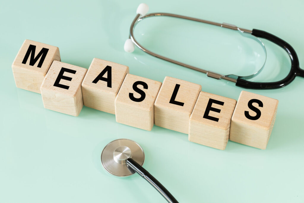 Wood letter cubes spelling measles