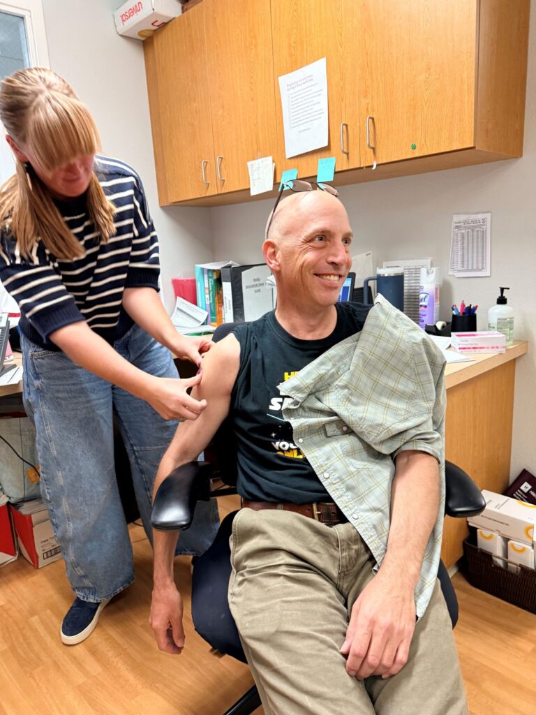 Dr. Hertzig getting vaccine from Nurse Megan